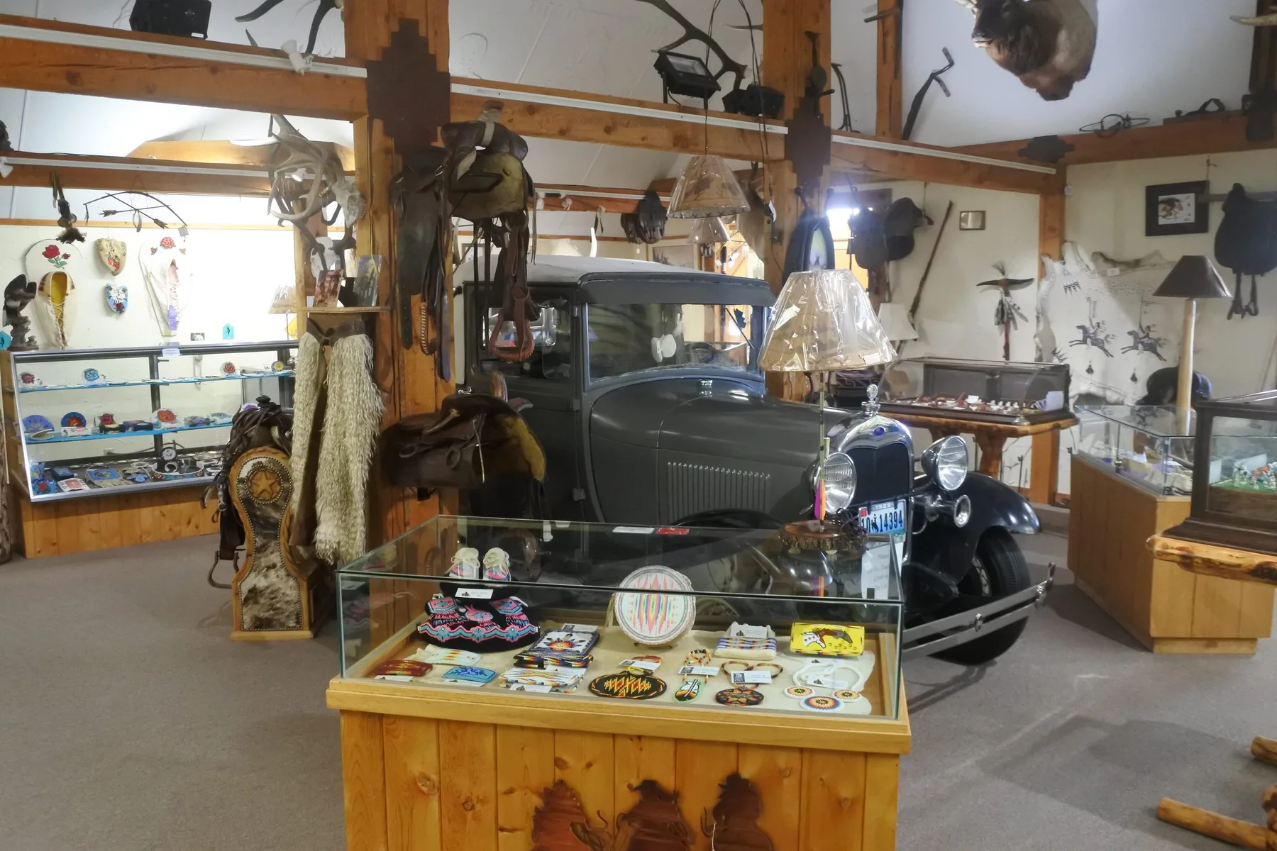 Gallery of the Wind room with a historic car and display cases inside Wind River Trading Company