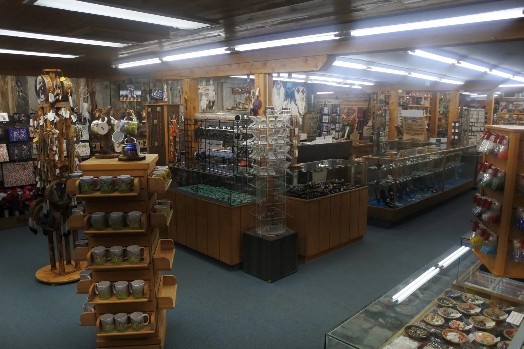 Sales floor with cases, gift goods, and handmade jewelry inside Wind River Trading Company