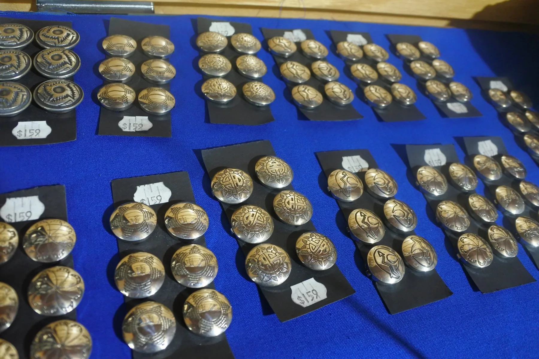Silver button covers displayed inside Wind River Trading Company